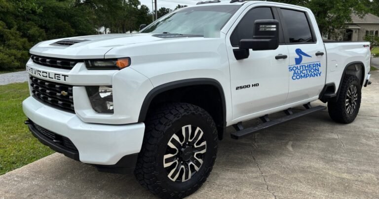 White lifted 2021 Silverado 2500HD with Southern Auction Company door logo